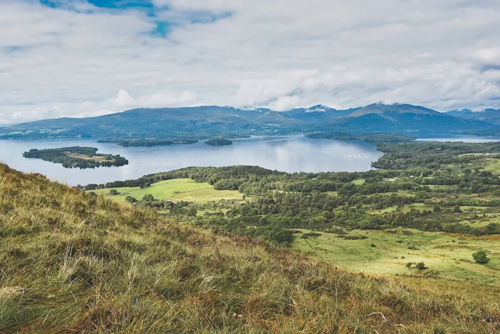 Scenic view of Loch Lomond and its islands, a popular wild camping destination in Scotland.