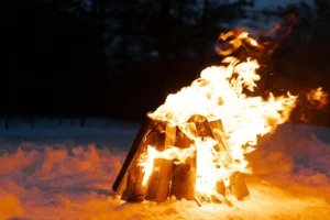 Strong campfire burning in snowy winter conditions