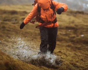 person hiking in rain with waterproofs on